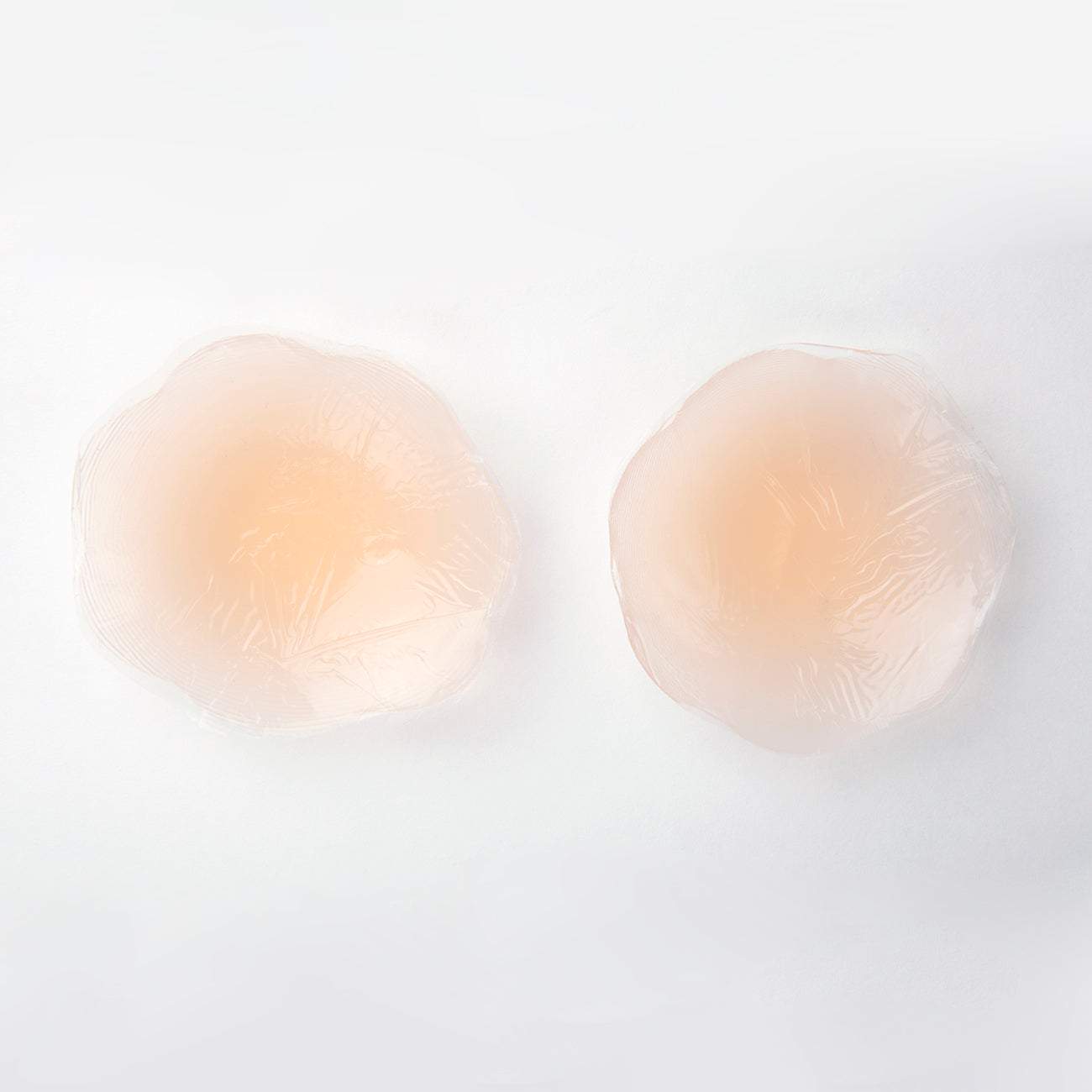 Underside of the full figure gel petals product shot. You can see how the petal can conceal and adhere to the nipple. Petals are nude in color.