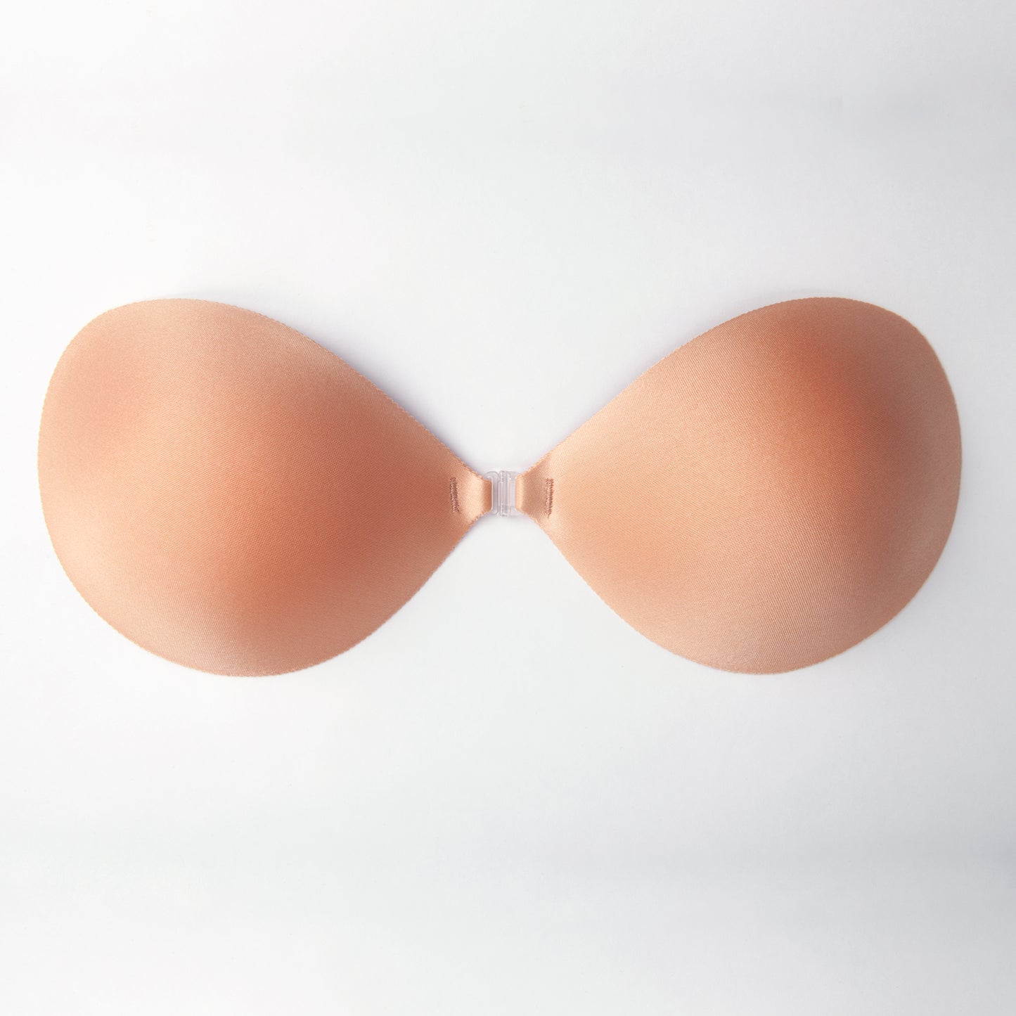 Close up image of the seamless nubra ultralite pushup. It is soft on the outside with a clip in the center. Bra is an orange-tinted beige.